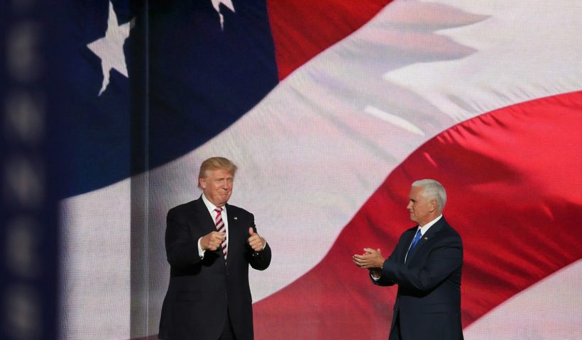 Donald Trump beside man in black suit