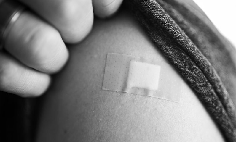 grayscale photo of person holding textile