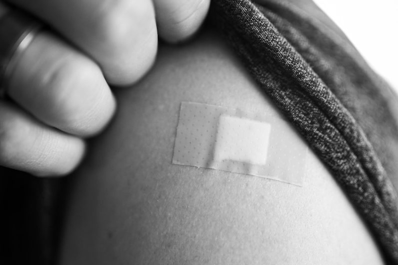 grayscale photo of person holding textile