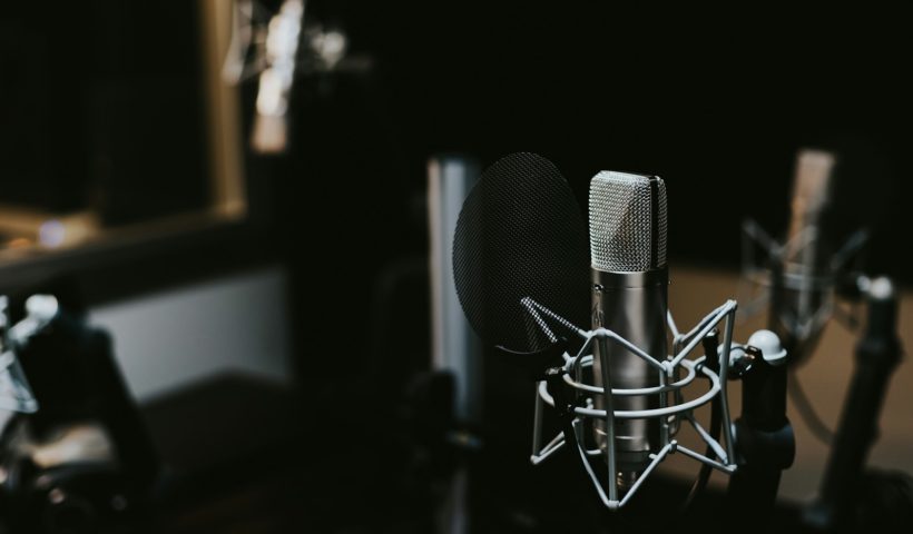 macro photography of silver and black studio microphone condenser
